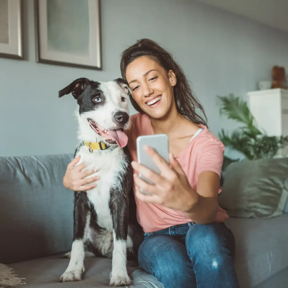 woman taking selfie with dog